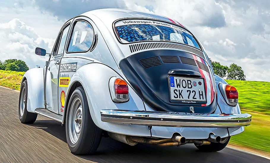 VW Käfer Der VW Käfer fahrend von hinten.