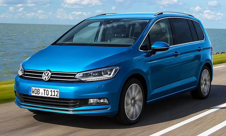 VW Touran (2015) Der VW Touran (2015) fährt über eine Küstenstraße, von vorne links fotografiert.