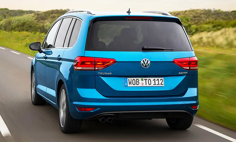 VW Touran (2015) Der VW Touran (2015) fährt über eine Landstraße, von hinten fotografiert.