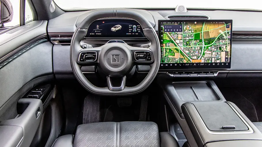 Das Cockpit des Zeekr 7X mit Lenkrad, digitaler Instrumentenanzeige und großem Touchscreen mit Karte neben einer breiten Mittelkonsole.